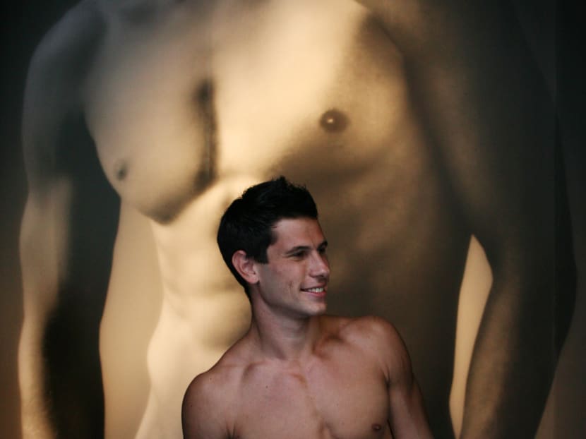 In this 2008 photo, a model prepares to greet shoppers at Abercrombie & Fitch in New York.  The retailer is saying goodbye to the beefcake models who greet customers at its doors. Photo: AP