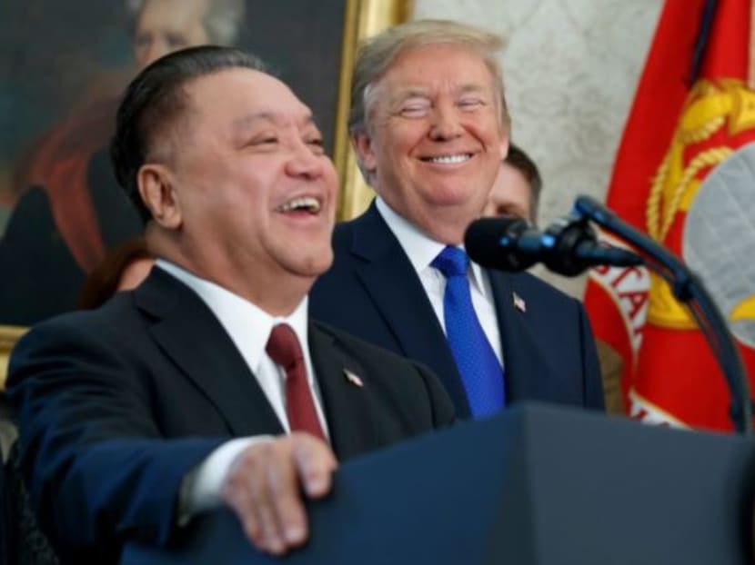 US President Donald Trump smiles at Broadcom CEO Hock Tan during an event to announce that the company is moving its global headquarters to the United States in the Oval Office of the White House on Thursday (Nov 2). Photo: AP
