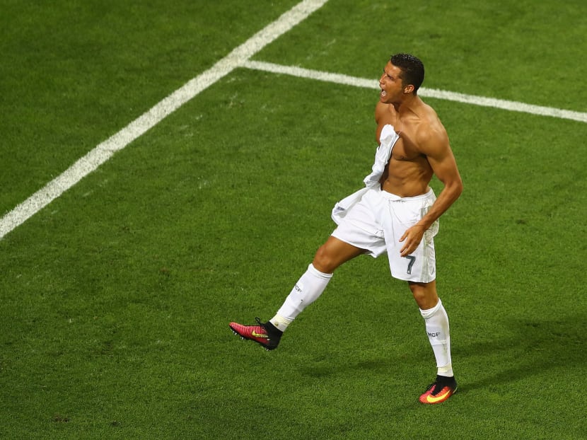 Cristiano Ronaldo of Real Madrid takes off his shirt in celebration after scoring the winning penalty in the penalty shoot out during the UEFA Champions League Final match between Real Madrid and Club Atletico de Madrid at Stadio Giuseppe Meazza on May 28, 2016 in Milan, Italy. Photo: Getty Images