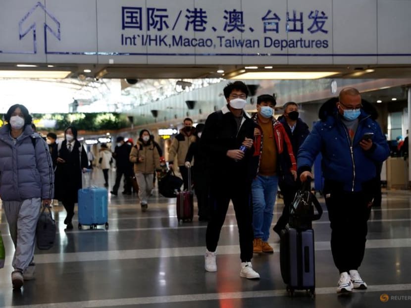 Travellers walk with their luggage at Beijing Capital International Airport, amid the coronavirus disease (Covid-19) outbreak in Beijing, China Dec 27, 2022.