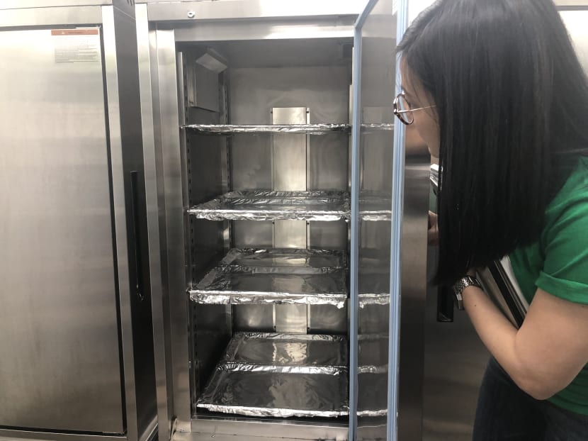 After the meals are cooked in advance by the hawkers, they will be stored in warmers such as this one, at Commonwealth, one of five "hawker hubs" operated by GrabFood. Customers can then order the meals until the food is sold out.