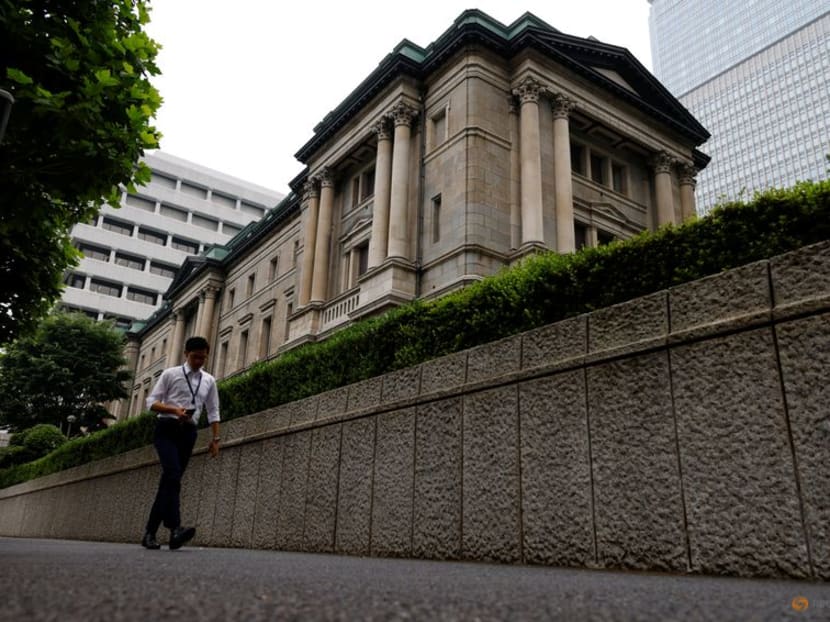 FILE PHOTO: A man walks past Bank of Japan's headquarters in Tokyo, Japan, June 17, 2022. REUTERS/Kim Kyung-Hoon