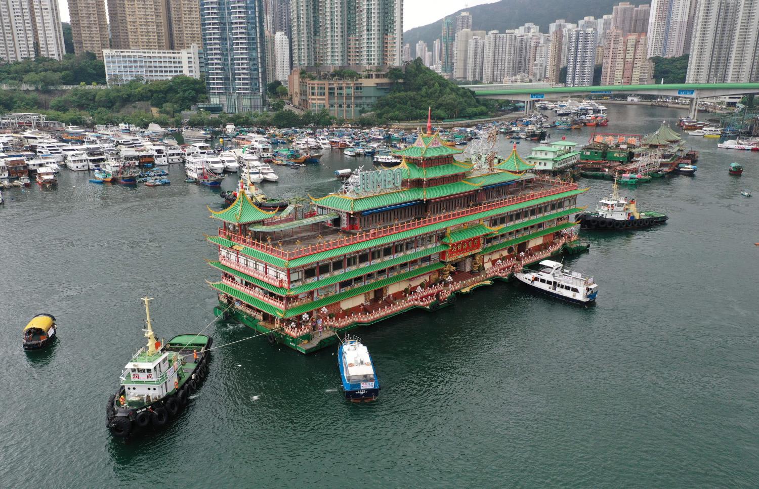 This file photo taken on June 14, 2022 shows an aerial view of Hong Kong's Jumbo Floating Restaurant being towed out of Aberdeen Harbour.