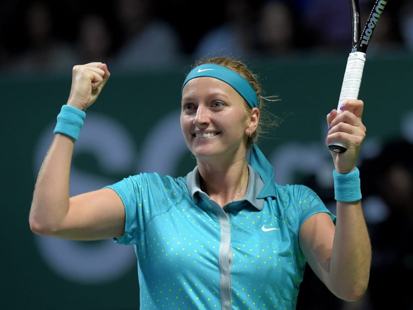 Petra Kvitova of the Czech Republic celebrates after defeating Russia's Maria Sharapova in their singles match at the WTA tennis finals in Singapore, Thursday, Oct 23, 2014. Photo: AP