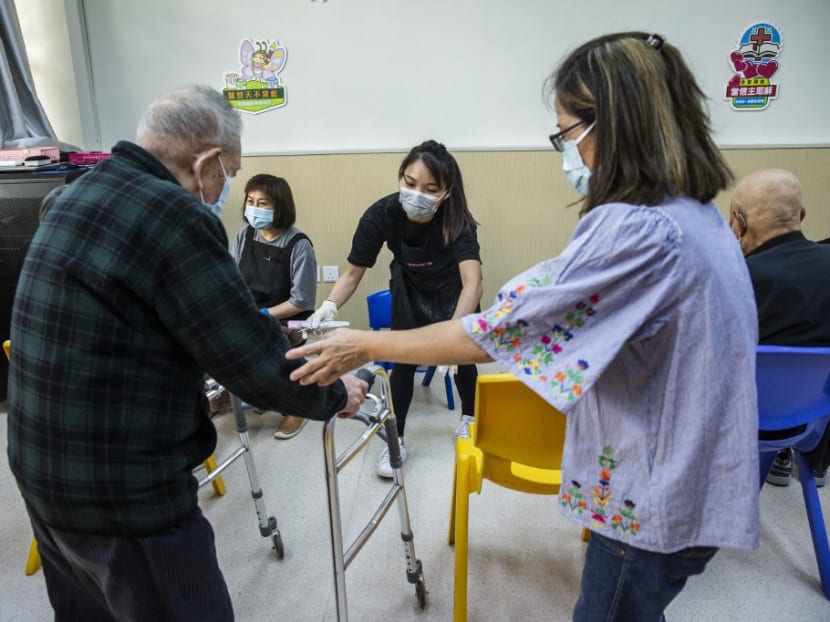 This photo taken on Nov 8, 2021 shows nail salon owner Cass Ng (centre) helping an elderly man before giving him a pedicure at a community centre for the elderly in Hong Kong as part of a charity initiative. This photo taken on Nov 8, 2021 shows nail salon owner Cass Ng (centre) helping an elderly man before giving him a pedicure at a community centre for the elderly in Hong Kong as part of a charity initiative.