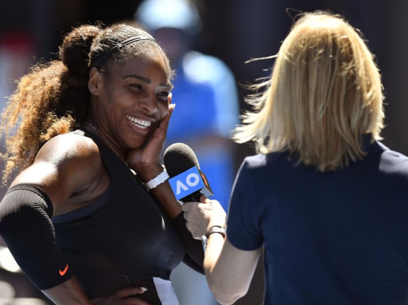 Serena Williams (left) is all smiles as she is interviewed at courtside during the Australian Open. Photo: AP