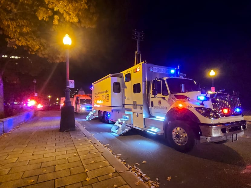 A Police truck is parked near the National Assembly of Quebec, in Quebec City, early on Nov 1, 2020, after two people were killed and five wounded by a sword-wielding suspect dressed in medieval clothing.