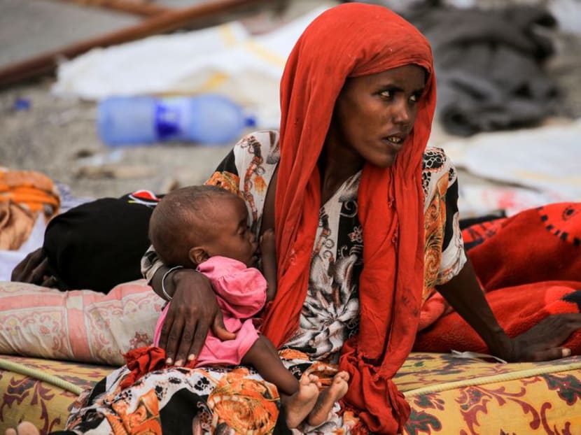 A mother feeds her severely malnourished child at a camp for internally displaced people in Afdera town in Afar region, Ethiopia, February 23, 2022. 