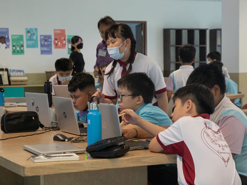 Students from special education school Grace Orchard School being mentored by students from Rulang Primary School during a coding class on March 23, 2023.
