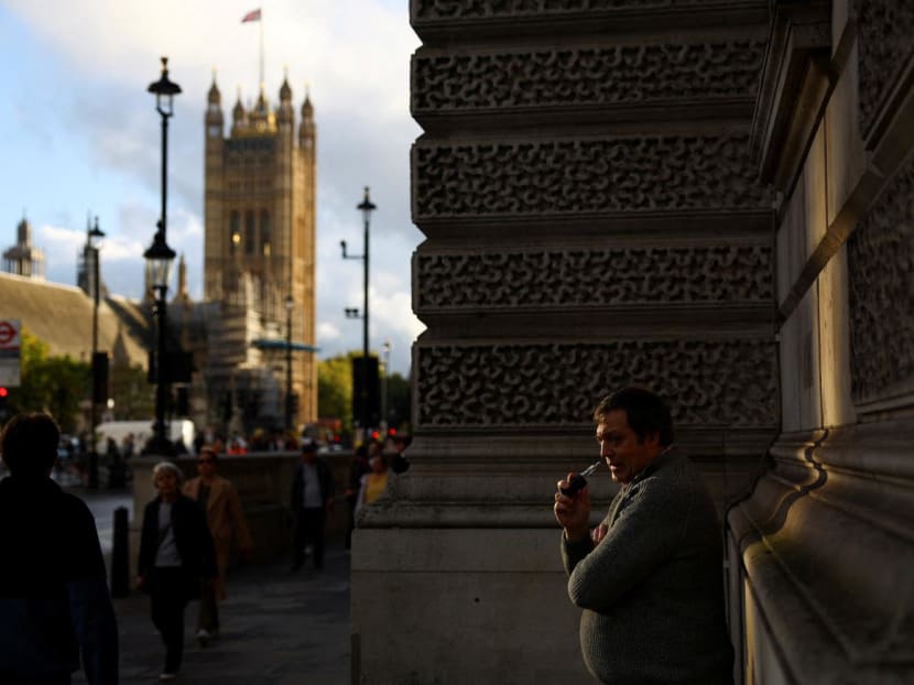 A man vapes outside the Houses of Parliament, in London, Britain on Oct 20, 2022.