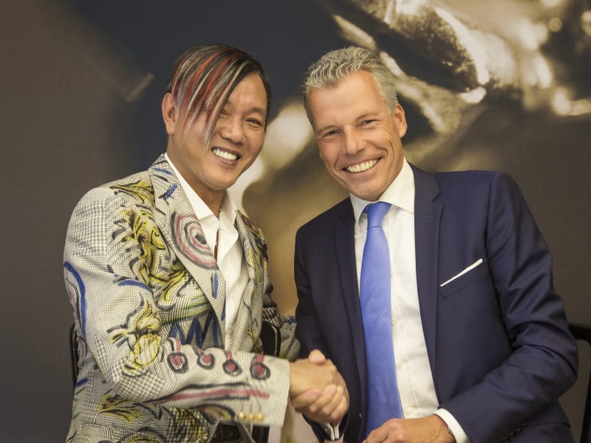 Chairman Stephen Hung, left, poses with Rolls-Royce Motor Cars CEO Torsten Mueller-Oetvoes at the Rolls-Royce's headquarters in Goodwood, Britain. Photo: AP/Rolls-Royce Motor Cars