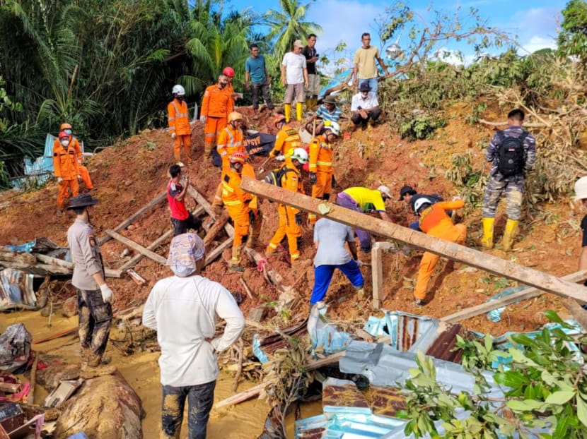 A rescue team evacuating the body of a victim that was found buried by a landslide at Pangkalan village, in Natuna Islands.