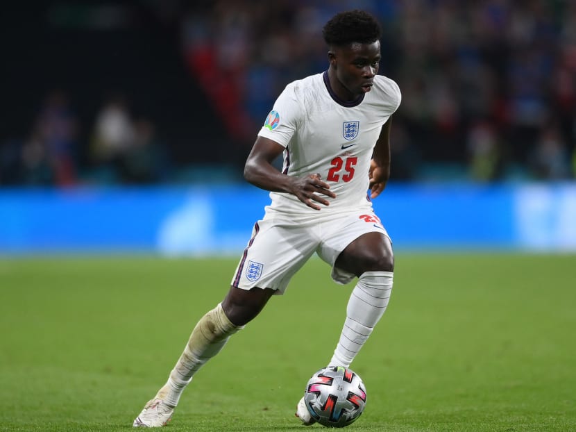 England's midfielder Bukayo Saka runs with the ball during the Uefa Euro 2020 final football match between Italy and England at the Wembley Stadium in London, UK on July 11, 2021.