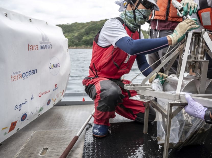 This photo taken on Oct 14, 2021 shows researchers preparing to take sediment samples collected from a "Smith-McIntyre" grab machine in the sea during a joint project of the French Tara Ocean Foundation and Japanese marine-station network Jambio onboard a boat off the coast of Shimoda, Shizuoka prefecture.