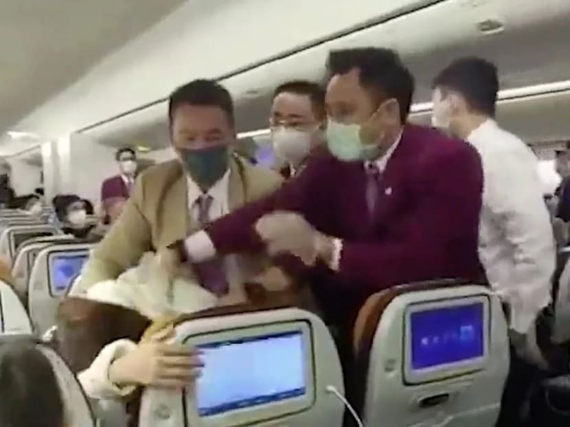 Video taken on board a Thai Airways flight at Shanghai on Friday purports to show flight attendants trying to control a passenger who coughed on one of their colleagues.