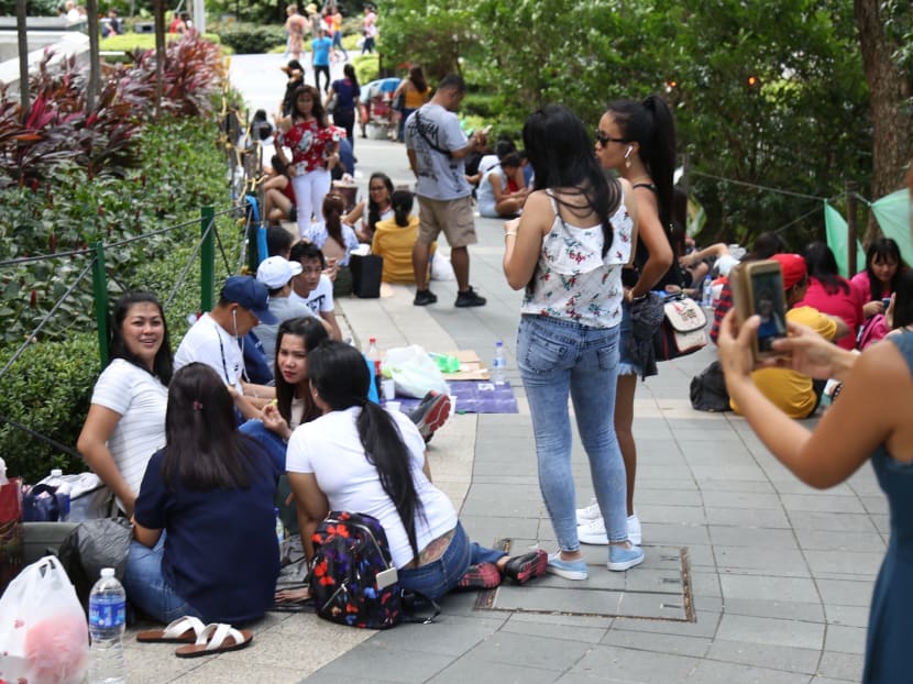 Foreign domestic workers spending time on Orchard Road before the coronavirus outbreak in Singapore. They have been told by the authorities to try and stay home if possible.