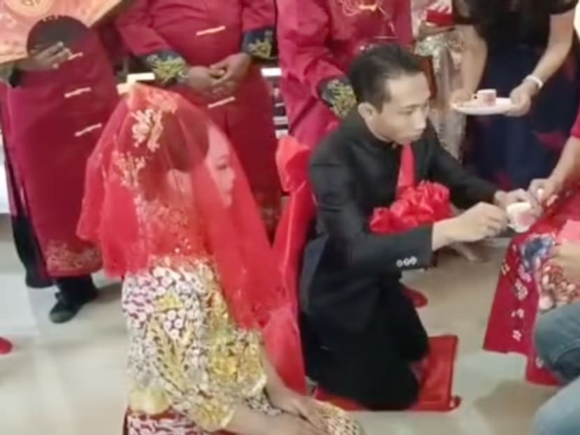A Malay groom pictured offering tea to his new in-laws in a traditional Chinese wedding tea ceremony.