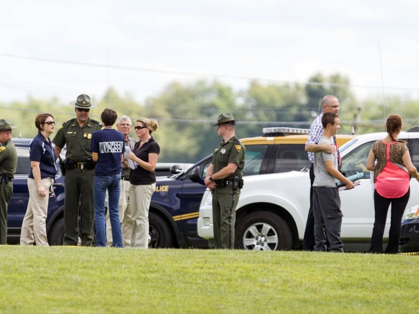 West Virginia Police and school officials help parents reunite with their children at Philip Barbour High School following a "hostage-type situation" on Aug 25, 2015, in Philippi, West Virginia. Photo: AP