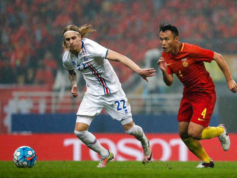 The Chinese national football team, seen here in action during their 0-1 loss to Iceland in the Gree China Cup International Football Championship match on Tuesday, are ranked 82nd in the world, and have qualified only once for the World Cup finals, in 2002, where they failed to win a match or score a goal. PHOTO: GETTY IMAGES