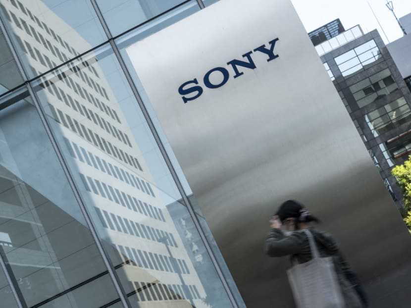 This photo taken on Oct 31, 2022 shows a woman walking past the Sony logo outside the company's headquarters in Tokyo.