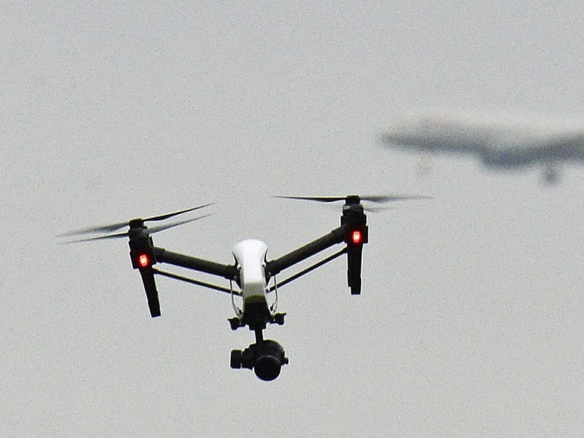 A drone flies in Hanworth Park in west London, as a British Airways 747 plane prepares to land at Heathrow Airport behind. AP file photo