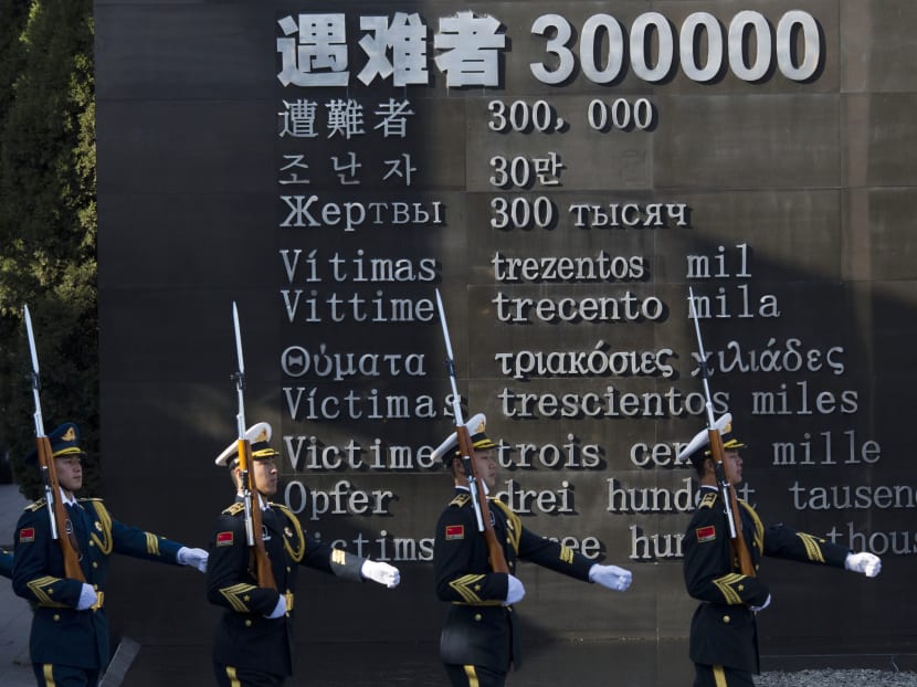 Chinese honour guard members march past the words "Victims 300000" during a ceremony to mark China's first National Memorial Day at the Nanjing Massacre Memorial Hall in Nanjing in eastern China's Jiangsu province Dec 13, 2014. Photo: AP