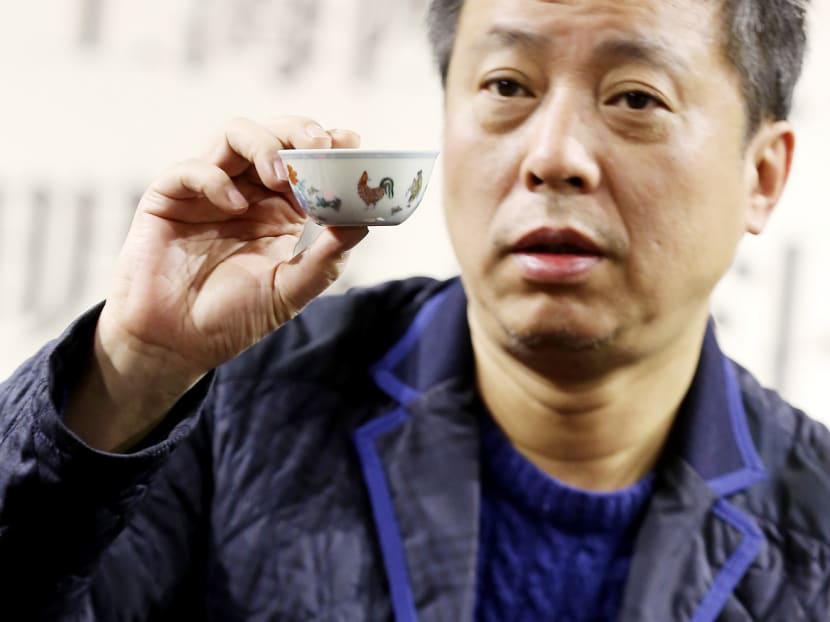 Mr Liu Yiqian shows the porcelain Ming Dynasty ‘Chicken Cup’, which the billionaire drank tea from after buying it for US$36 million. His treatment of the historical artefact drew outrage from Chinese netizens. Photo: AP