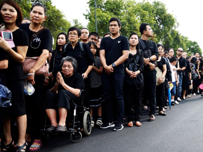 Mourners waiting outside the Grand Palace to pay their respects to the late King Bhumibol Adulyadej in Bangkok, yesterday. The country began observing a one-year mourning period after the monarch died on Thursday. The huge demand for black clothing has raised fears of a national shortage. PHOTO: REUTERS