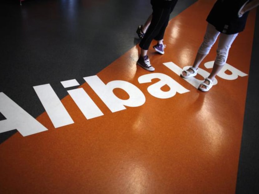 Employees stand on a logo of Alibaba during a media tour organised by government officials at its headquarters on the outskirts of Hangzhou, Zhejiang province on June 20, 2012. Photo: Reuters