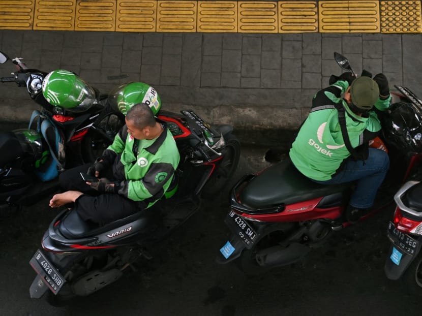 This file photo taken on April 11, 2022 shows Gojek motorcycle ride-hailing service riders waiting for customers in Jakarta. 