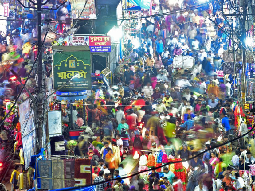 People walking through a market in Allahabad, India, on Oct 22, 2022.