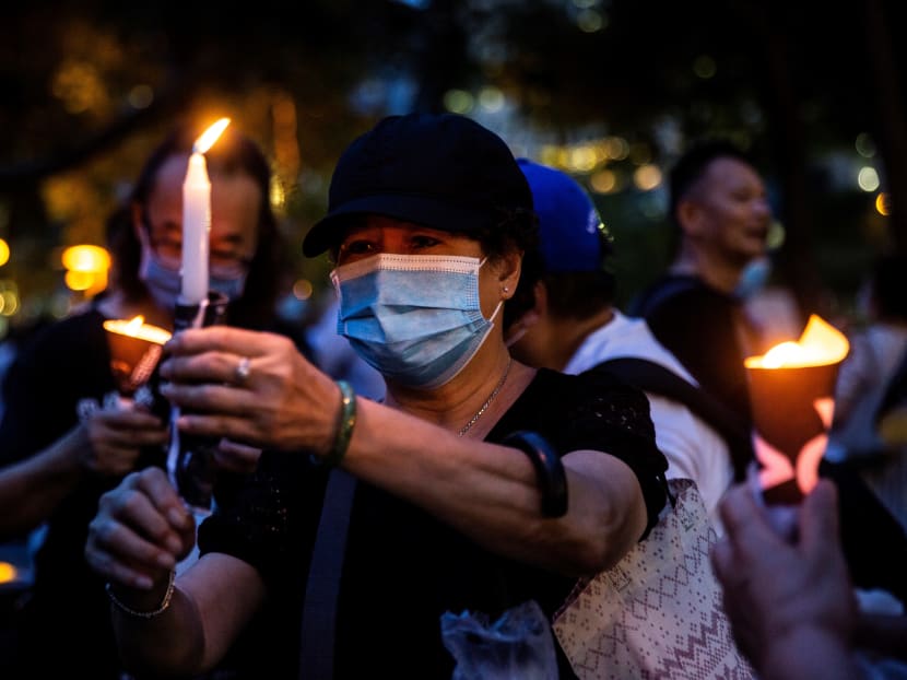 Activists light candles during a remembrance gathering outside Victoria Park in Hong Kong on June 4, 2020, after an annual vigil that traditionally takes place in the park to mark the 1989 Tiananmen Square crackdown was banned on public health grounds because of Covid-19.