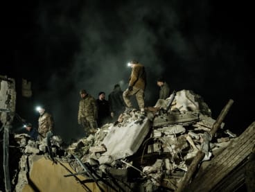 Rescuers remove debris to search for survivors at a destroyed apartment building hit by a rocket during the night in downtown Kramatorsk on Feb 1, 2023, amid the Russian invasion of Ukraine. 