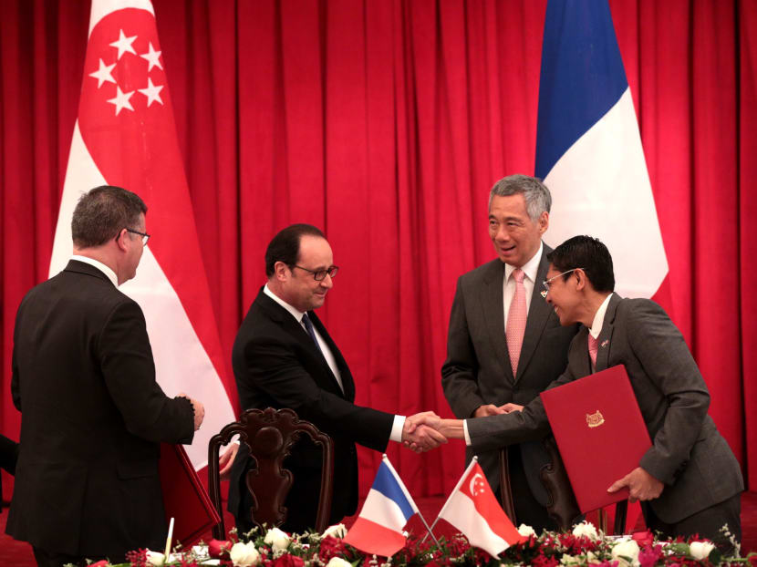Prime Minister Lee Hsien Loong and France’s President François Hollande at the signing of the Competent Authority Agreement, which covers the automatic exchange of financial account information. Photo: Jason Quah/TODAY