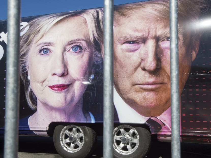 Large images of Democratic nominee Hillary Clinton and Republican nominee Donald Trump are seen on a CNN vehicle, behind asecurity fence, on Sept 24, 2016, at Hofstra University, in Hempsted, New York. Photo: AFP
