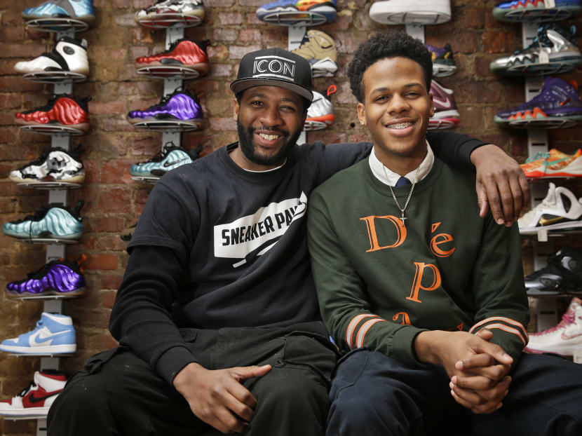 Entrepreneurs Chase Reed, right, and his father Troy Reed pose for a picture in their store in the Harlem section of New York. Photo: AP