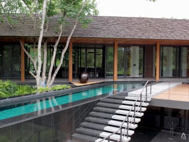 A swimming pool takes centre stage at this tropical modernist architecture in Thailand