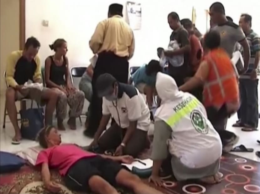 In this image taken from video on Aug 17, 2014, survivors are checked by paramedics in Lombok, Indonesia, after a boat sank Saturday evening on its way from Lombok island to Komodo island.  Photo: AP