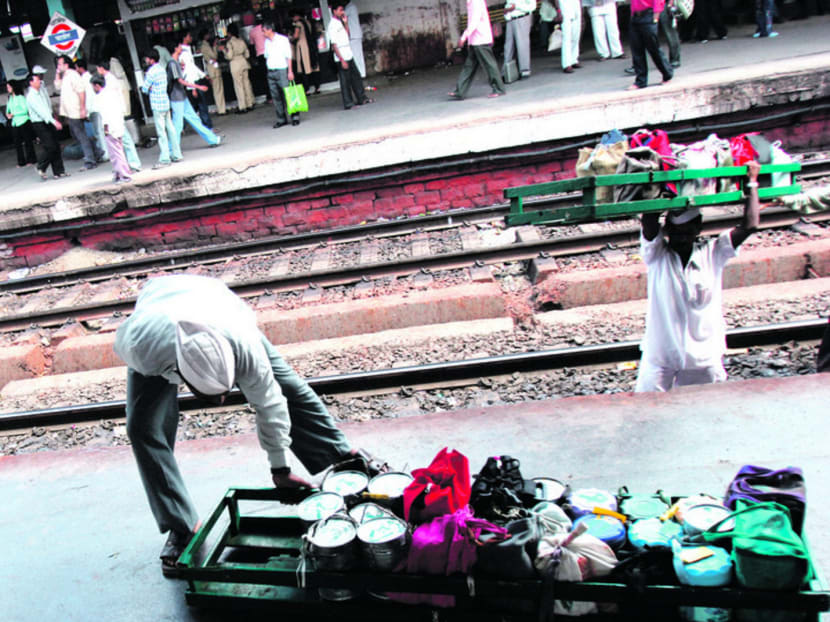 The dabbawallas are organised into teams of 20, collecting lunch boxes, sorting them by destination and loading them on to Mumbai’s trains.  Photo: Bloomberg