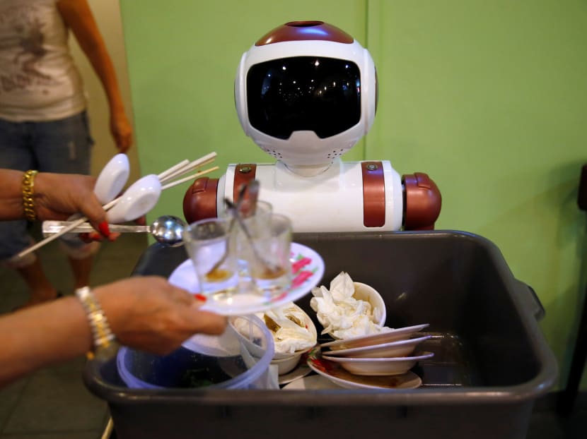 A robot collecting dishes to be cleaned at Chilli Padi Nonya Cafe. The machine lacks the ability to pick up cups and plates itself. Instead customers place their used crockery in a tray it carries to the kitchen. PHOTO: REUTERS