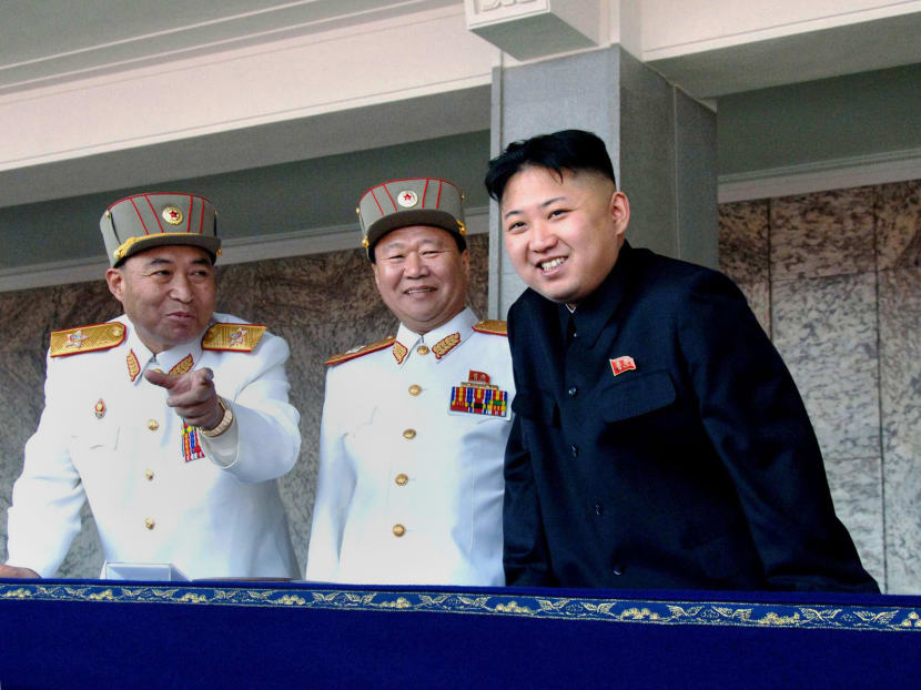 This file picture taken by North Korea's official Korean Central News Agency on April 15, 2012 shows North Korean leader Kim Jong-Un (R) smiling with North Korea's army chief Ri Yong-Ho (L) and another military officer as he reviews a military parade commemorating the 100th birth anniversary of former North Korean President Kim Il Sung at the Kim Il Sung Square in Pyongyang. Photo: AFP