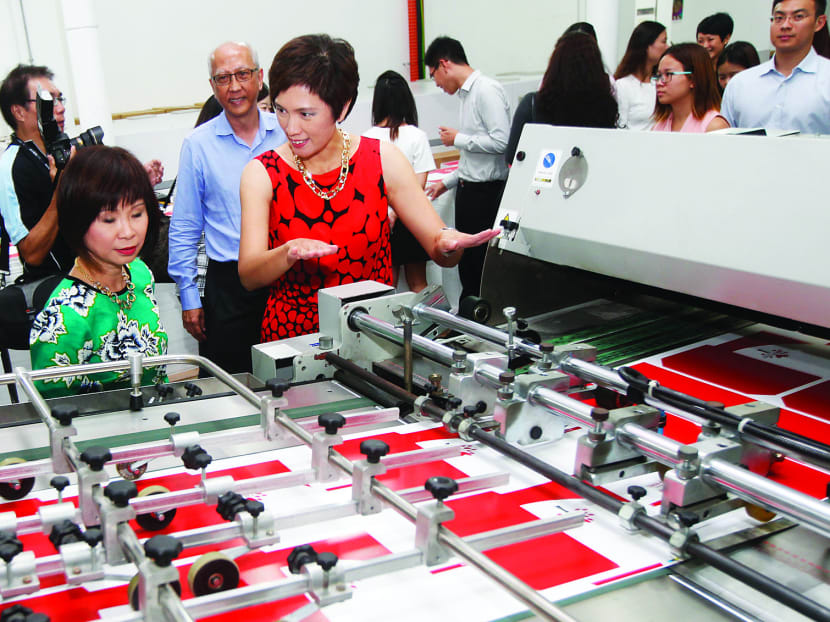 Senior Minister of State (Health) Amy Khor (left) and Senior Minister of State (Finance and Transport) Josephine Teo toured the production site for the Pioneer Generation Package welcome pack yesterday. Photo: Wee Teck Hian