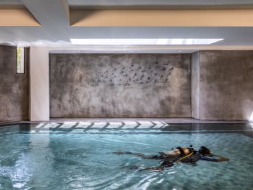 A heated pool in the basement of this Singapore home serves as the ‘office’ for its owners
