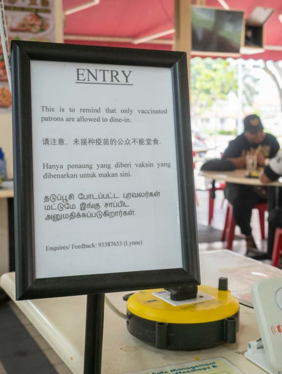 A sign reminding visitors that only two vaccinated persons are allowed to dine together at T&D 136 Coffeeshop on Jan 17, 2022.