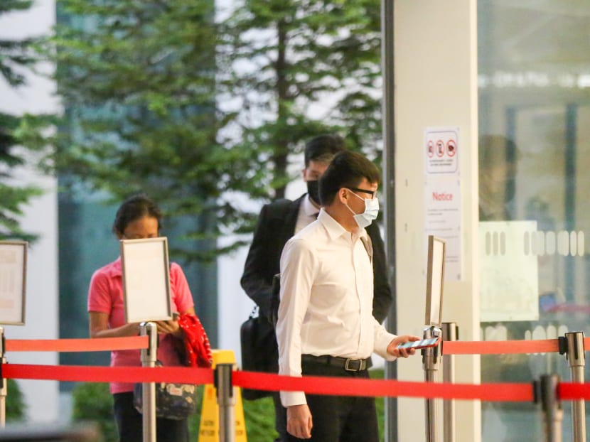 Thomas Cher Junxian (foreground) arriving at the State Courts on April 21, 2022. Thomas Cher Junxian (foreground) arriving at the State Courts on April 21, 2022.