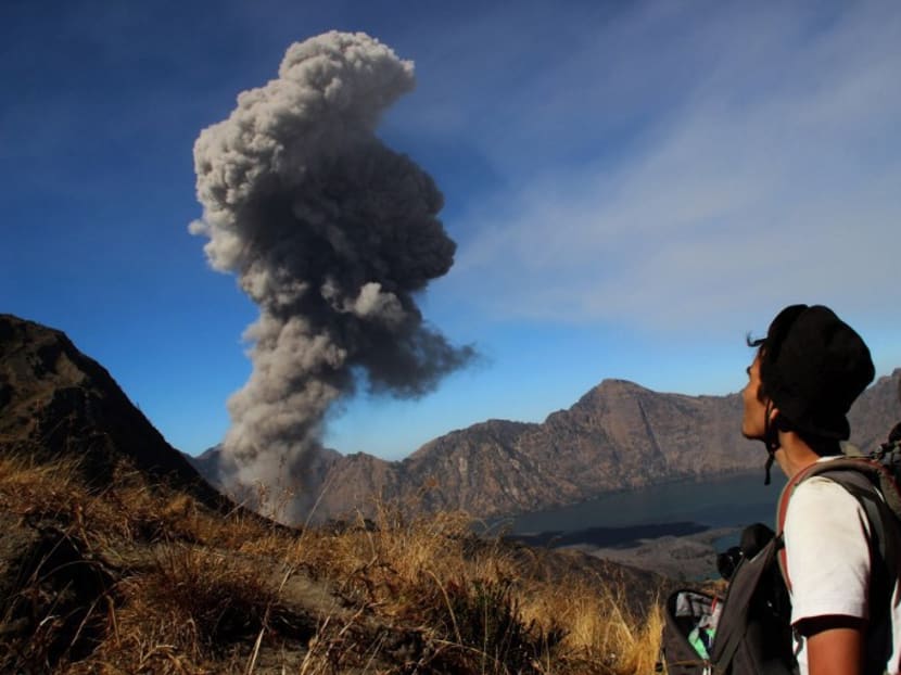 An Indonesian looking on as Mount Barujari spews volcanic ash in Lombok in 2015. Photo: AFP