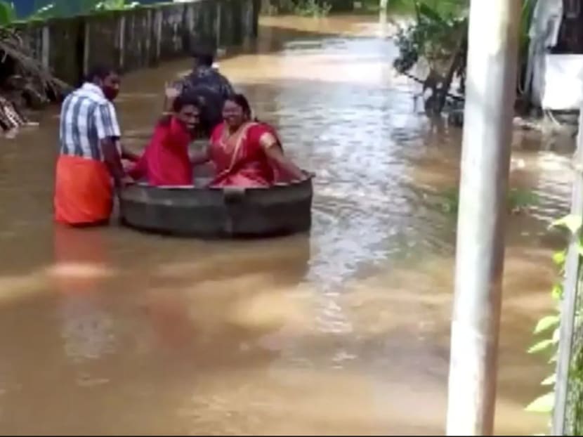 Floods force Indian couple to float to their wedding — in a cooking pot Floods force Indian couple to float to their wedding — in a cooking pot