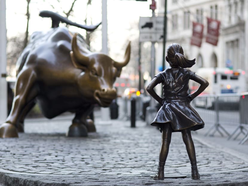 The Charging Bull and Fearless Girl statues are shown on Lower Broadway in New York. Since 1989 the bronze bull has stood in New York City's financial district as an image of the might and hard-charging spirit of Wall Street. But the installation of the bold girl defiantly standing in the bull's path has transformed the meaning of one of New York's best-known public artworks. Pressure is mounting on the city to let the Fearless Girl stay. Photo: AP