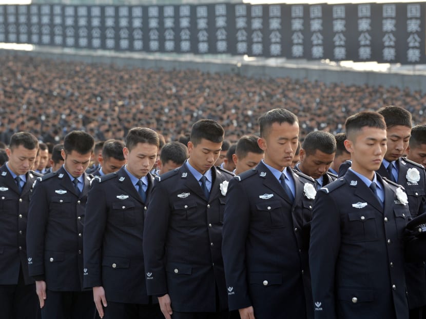 Police pay a silent tribute during a memorial ceremony to mark the 80th anniversary of the 1937 Nanjing Massacre. At the ceremony, a top Chinese official stressed the need for China and Japan to build on their "long, rich history" of links and to deepen their "friendship". Photo: Reuters