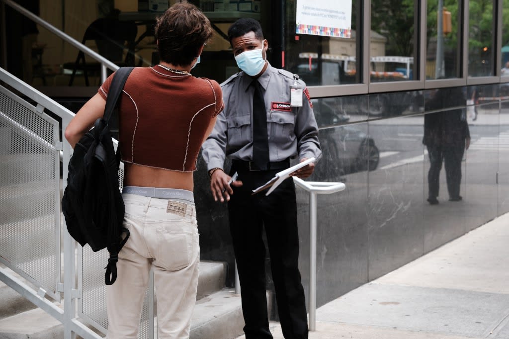 A security guard speaks to people at a healthcare facility that is administering the monkeypox vaccine by appointment on Aug 5, 2022 in New York City. 